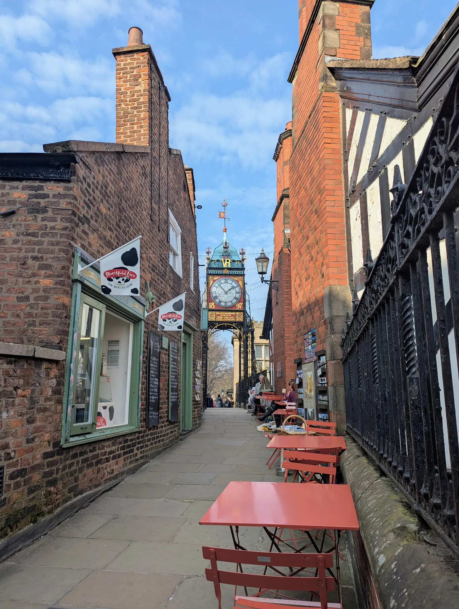 The Eastgate Clock above the street with timber-framed buildings