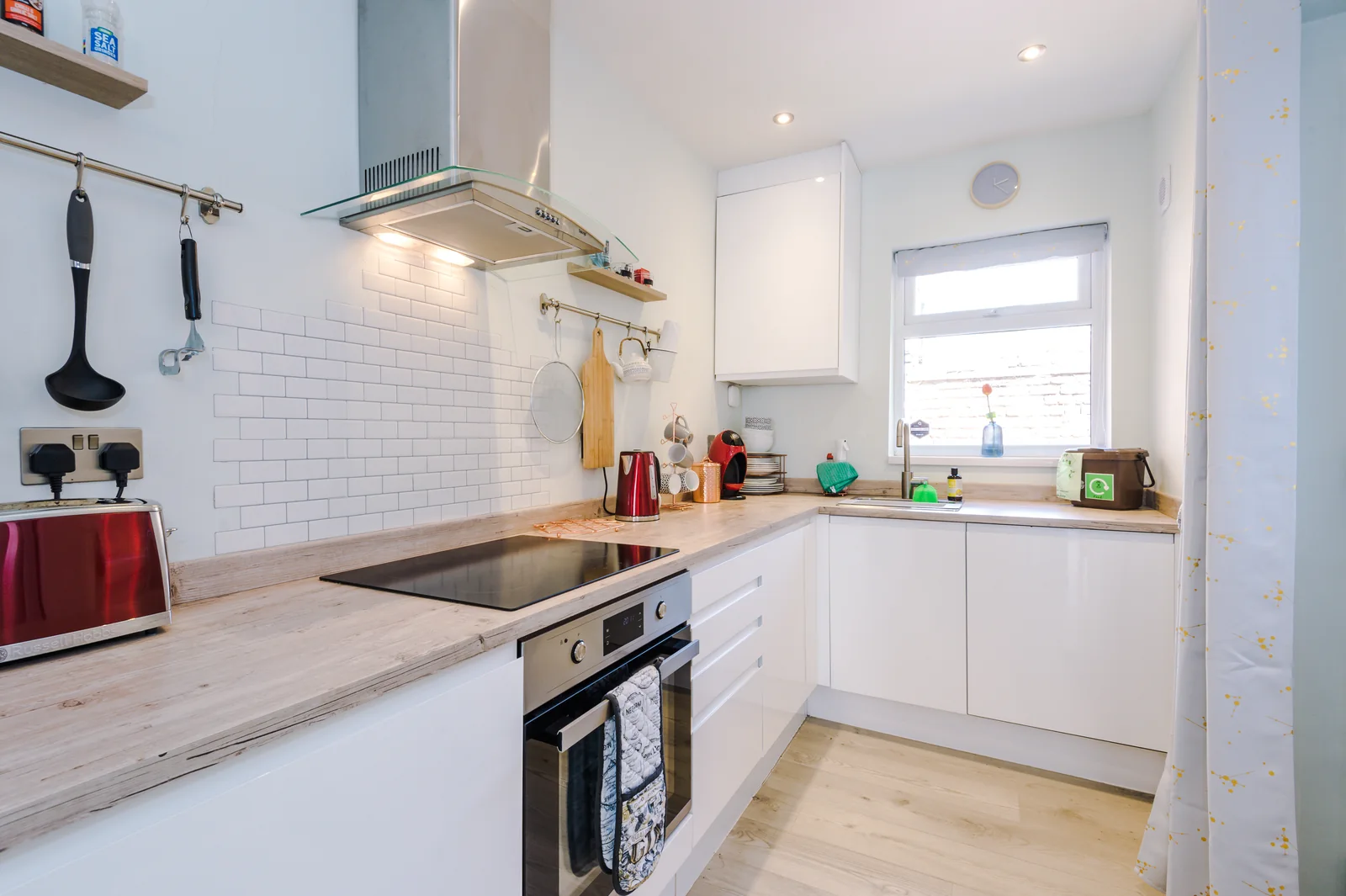 Bright fitted kitchen with wooden worktops, oven and hob at Enjoy the Pause